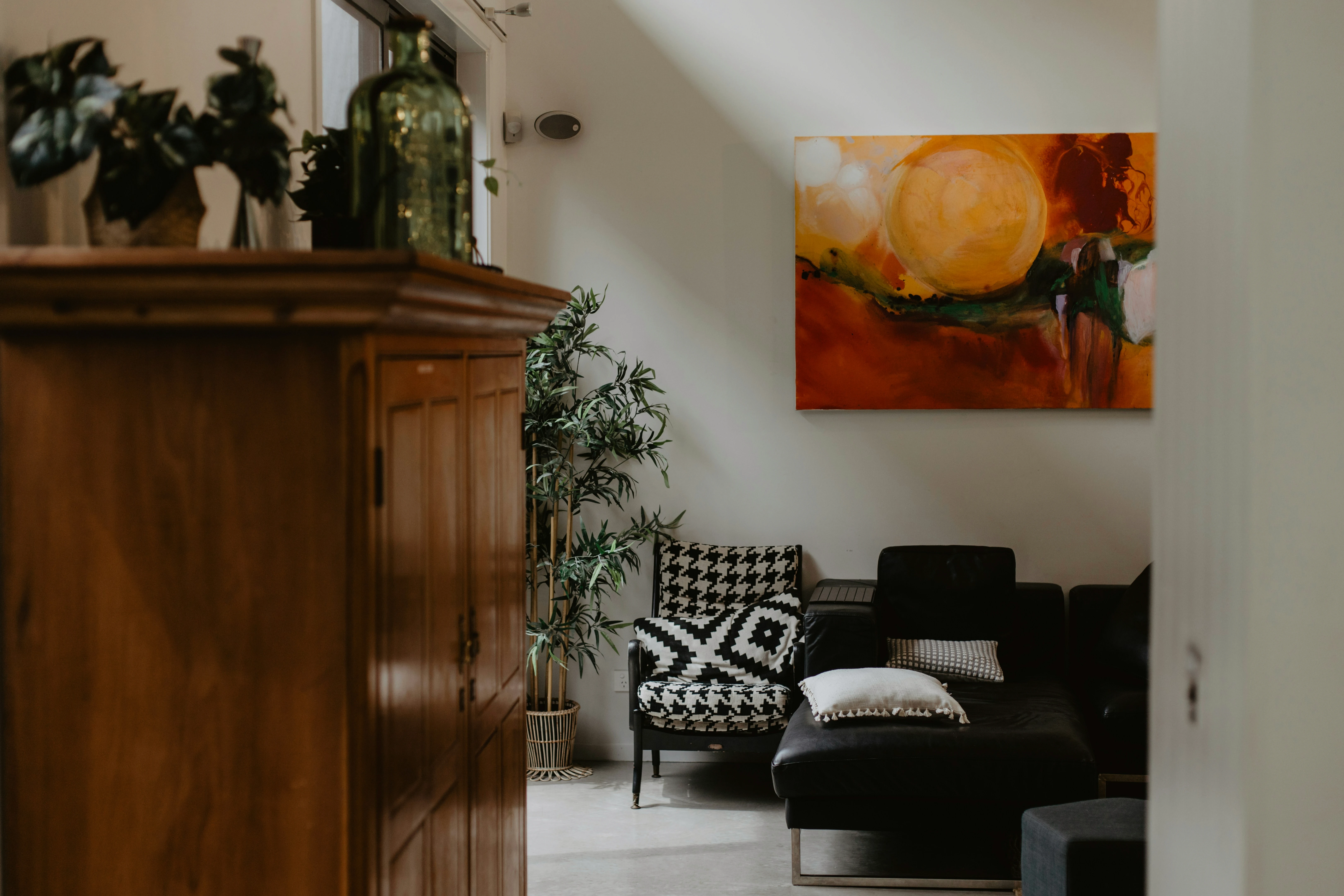 a living room with a couch and a painting on the wall